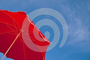 Red beach umbrella and blue sky