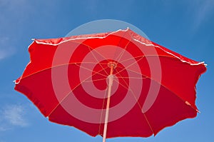 Red beach umbrella and blue sky