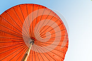 Red beach umbrella with blue sky