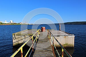 A red beacon light on a cement platform in the Strait of Canso near Port Hawkesbury Nova Scotia