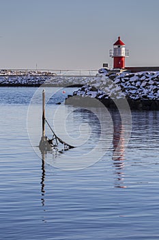 Red beacon at the Moskenes harbour entrance photo