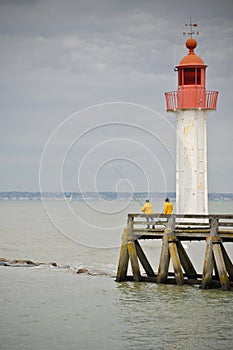 Red beacon with two anglers