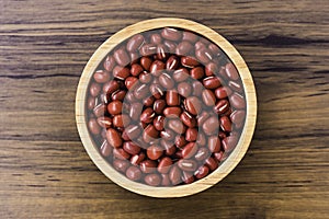 Red small Azuki beans  Adzuki or japanese red bean  in wooden bowl isolated on wood table