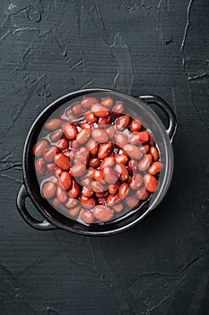 Red bean, canned food, on black background, top view flat lay