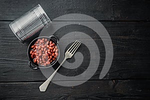 Red bean, canned food, on black wooden table background, top view flat lay  with copy space for text