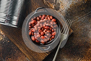 Red bean, canned food, on old dark rustic background, top view flat lay