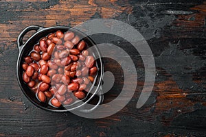 Red bean, canned food, on old dark  wooden table background, top view flat lay  with copy space for text