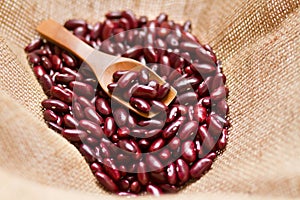 Red bean with wooden spoon in linen sack bag