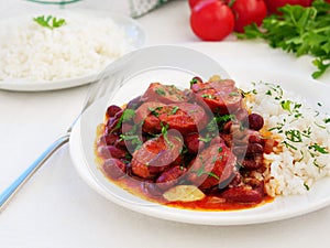 Red beans and rice with sausage on white table