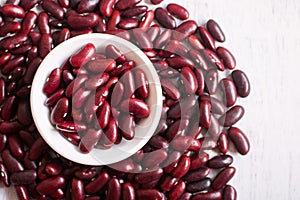 Red beans in white bowl on wooden background