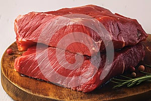 Red beef meat raw cow fillet presented on wooden board