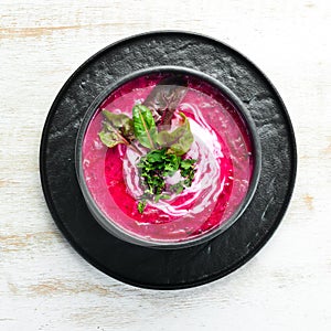 Red beet soup with sour cream. Ukrainian cuisine, Borsch soup. Top view.