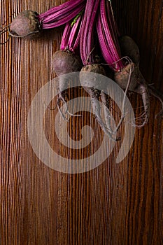 Red Beetroot with herbage green leaves on rustic background. Organic Beetroot.