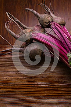 Red Beetroot with herbage green leaves on rustic background. Organic Beetroot.