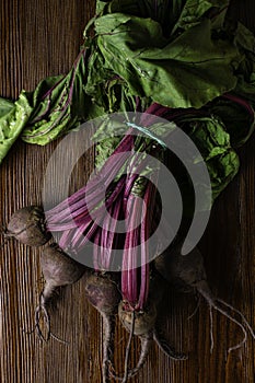 Red Beetroot with herbage green leaves on rustic background. Organic Beetroot. Detox