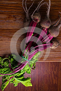 Red Beetroot with herbage green leaves on rustic background. Organic Beetroot. Detox. Selective focus