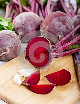 Red beetroot with herbage green leaves on wooden background photo