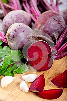 Red beetroot with herbage green leaves on wooden background photo