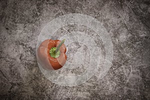 Red Bell Pepper on a Black Cement Background