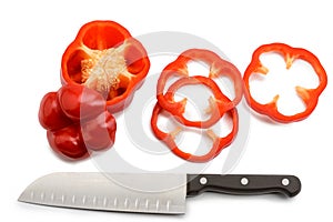 Red bell pepper and santoku knife on white background photo