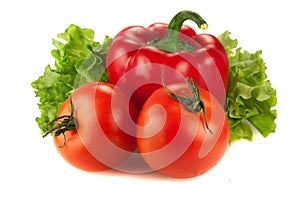 Red bell pepper and two tomatoes on lattuce over white background