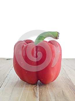 Red bell pepper on wooden