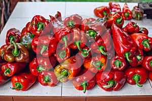 Red bell peppers on outdoor kitchen counter, grill barbecue setting