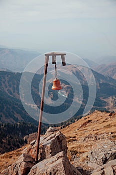 Red bell on the top of Bukreev peak mountain near Almaty in Kazakhstan