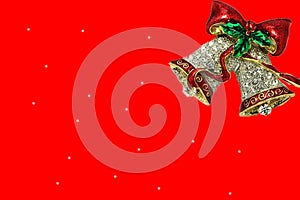 Red bells and white gift card on red background photo