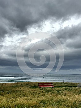 Red Bench in Easky Ireland- ocean view- cloudy day