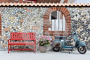 Red bench with flowers and motorcycle