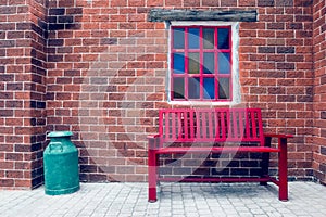 Red bench and windows on brick wall,filter effect
