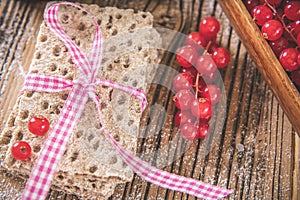 Red berries  with toast over wooden table