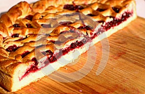 Red berry pies on wooden background