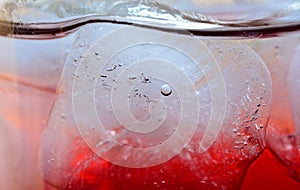 Red beverage with ice in circle dringking glass for abstrack ba