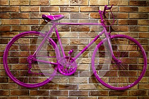 Red bicycle on a brick wall.