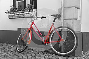 Red bicycle on cobblestone street in the old town, Black And White