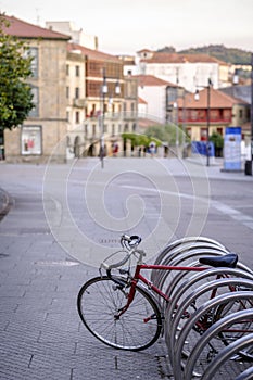 Red bicycle parked in a special parking area.