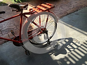 Red bicycle and shadow on the path