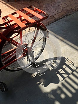 Red bicycle and shadow on the path