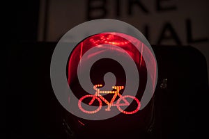 Red bicycle traffic stop light at night closeup