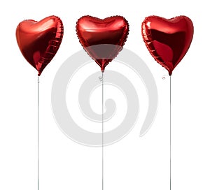 Red big heart metallic balloons on white