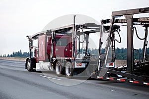 Red big rig classic semi truck car hauler with empty trailer run