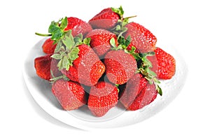 Red big strawberries in a white plate on a white background with water drops on berries isolate