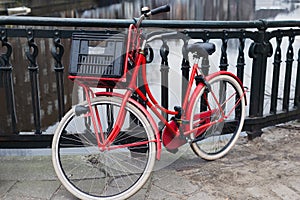 Red bike on bridge over gracht canal, Amsterdam photo