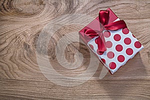 Red birthday present on wooden board celebrations concept