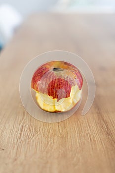 Red biten apple fruit on a wooden table