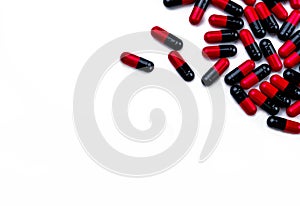 Red-black capsule pills isolated on white background with space for text. Pharmaceutics concept. Pharmaceutical industry.