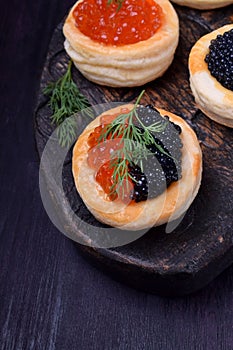 Red and black caviar in tartlets