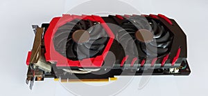 Red and black Computer graphics card with two fans isolated on white background.